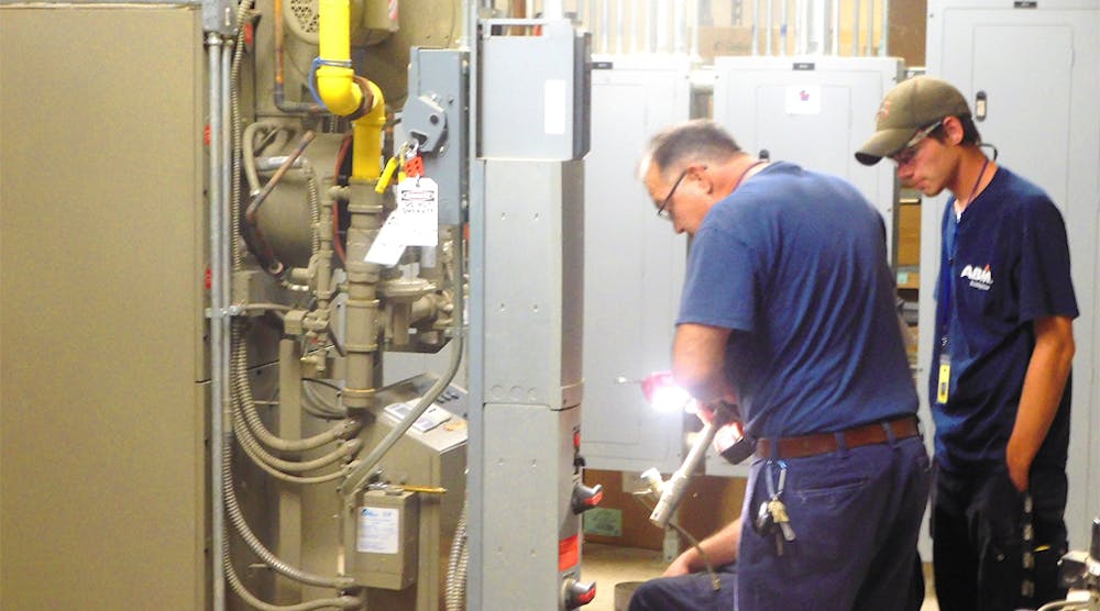 The Connellsville Area School District entered into an energy performance contract with facility solutions provider ABM to upgrade its HVAC, plumbing and energy infrastructure. The savings are estimated at $26.4 million over a 15-year period. Pictured is an ABM crew installing gas-fired boilers in an elementary school.