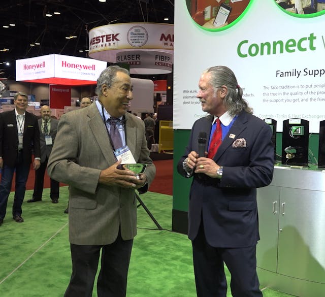 Bruce Marshall, on left, receives the Dan Holohan Lifetime Contribution to Comfort Award from John Hazen White, Jr., Executive Chairman of the Board of Taco Family of Companies, at Taco&rsquo;s AHR Expo booth on Jan. 22, 2018.
