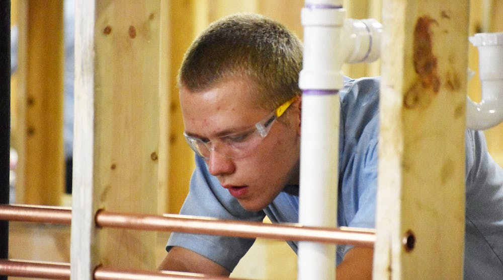 A plumbing apprentice checks an installation during the annual SkillsUSA National Leadership and Skills Contest, held June 25-29 in Louisville, Kentucky.