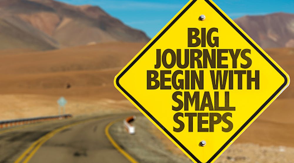 Big Journeys Begin With Small Steps sign with sky background