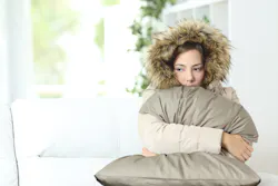 woman sitting in cold house