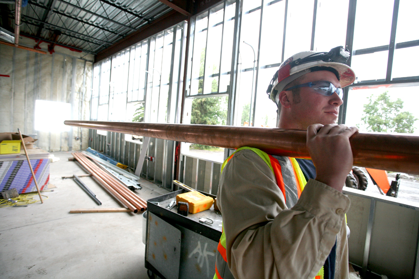 Weldins general foreman Stevan Bothell moves threeinch copper pipe used for the Flight Simulators singlepipe distribution system