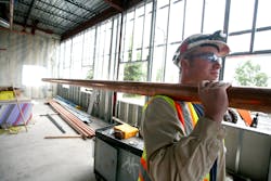 Weldins general foreman Stevan Bothell moves threeinch copper pipe used for the Flight Simulators singlepipe distribution system Weldins general foreman Stevan Bothell moves threeinch copper pipe used for the Flight Simulators singlepipe distribution system