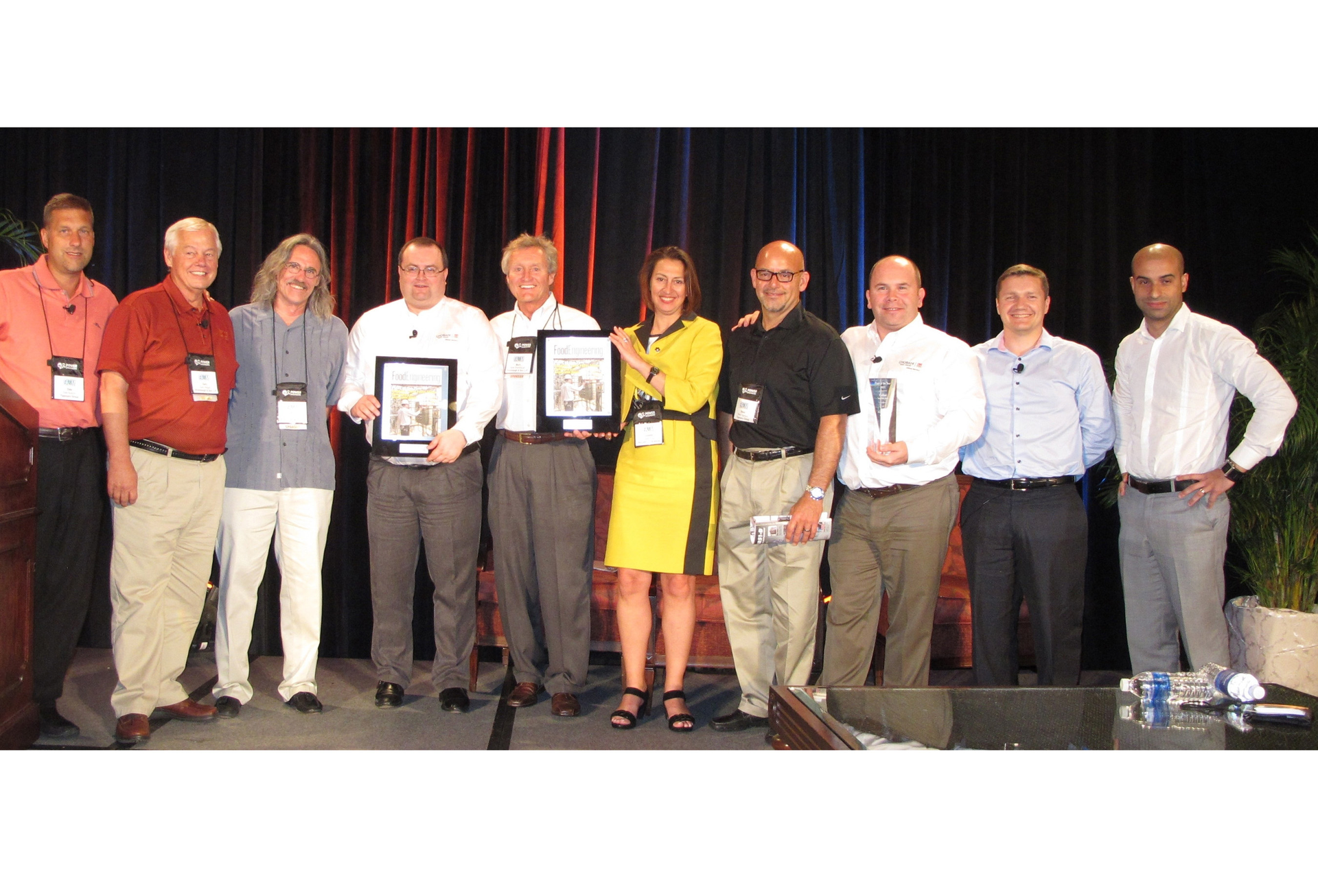 Showing their awards from left to right are Dale Budzon Group VP of Construction Tippmann Group Gary Hegger SVP Shambaugh Son Bob Keplinger W Region Operations Mgr Shambaugh Son Marc Abjean SVP Global Engineering Project Mgmt Chobani Inc Mark Shambaugh President CEO Shambaugh Son Julie Kipp Directeur De Division Boccard Steve Tippmann EVP Tippmann Group Hugh Roddy Sr Director Global AutomationControls Energy Mgmt Chobani Inc Phillipe Marie Responsible Filiere Alimentaire Boisson Division Food Pharma