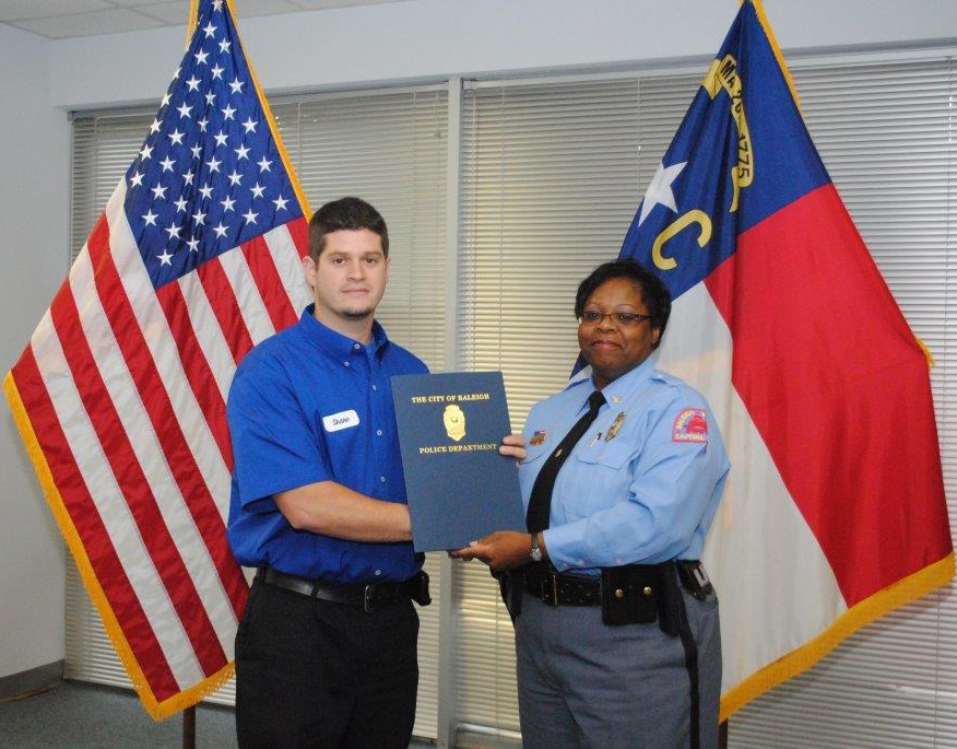 Shane St Pierre ARSRescue Rooter technician receives the citation from Cassandra L DeckBrown Raleigh Police Chief