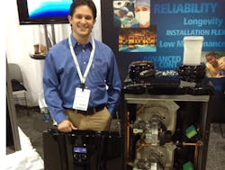 Aerco Product Solutions Manager Andrew Macaluso with the AM Series boiler Aerco Product Solutions Manager Andrew Macaluso with the AM Series boiler