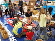 Thomas J Berlin a project engineer with Shapiro amp Duncan guides Pinebrook Elementary School students through a handson pipefitting discussion Shapiro amp Duncan is in Rockville Md and Pinebrook Elementary School is in Aldie Va