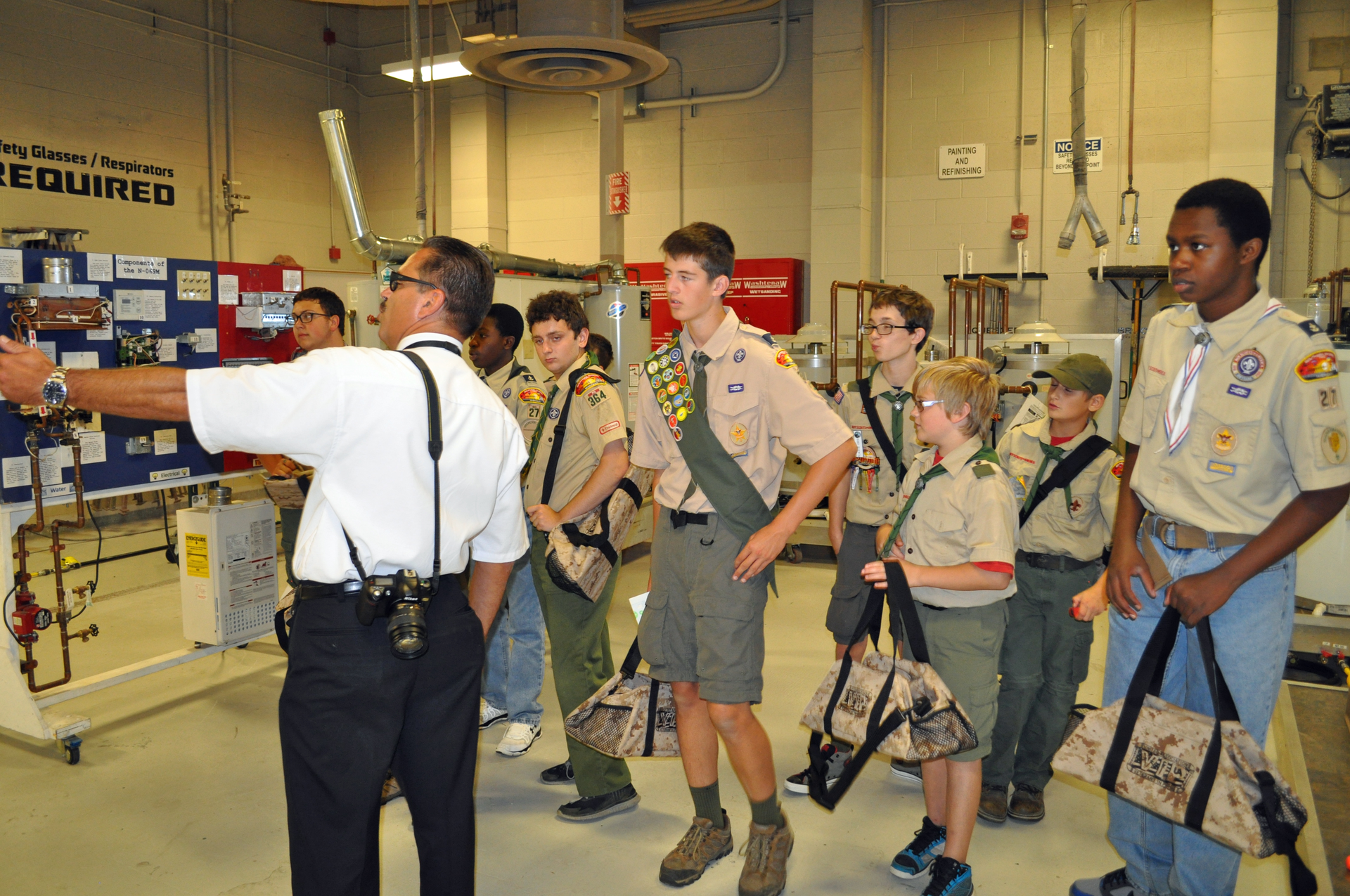 Plumbing Contractors Association of Chicago Director Brian Wilk Bishop Plumbing Inc leads a delegation of local Boy Scouts around the UArsquos Instructor Day training facilities at Washtenaw College in Ann Arbor Michigan