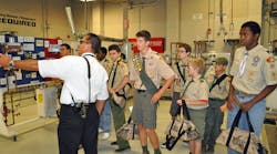 Plumbing Contractors Association of Chicago Director Brian Wilk, Bishop Plumbing Inc., leads a delegation of local Boy Scouts around the UA&rsquo;s Instructor Day training facilities at Washtenaw College in Ann Arbor, Michigan.