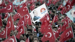 Supporters of Turkish President Tayyip Erdogan and Prime Minister and leader of the ruling Justice and Development Party (AKP) Ahmet Davutoglu wave national flags during a ceremony to mark the 562nd anniversary of the conquest of the city by Ottoman Turks on May 30, 2015 in Istanbul, Turkey.