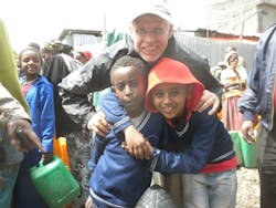 David Powell with some kids from Sendafa In the background are townspeople collecting water from the water truck David Powell with some kids from Sendafa In the background are townspeople collecting water from the water truck