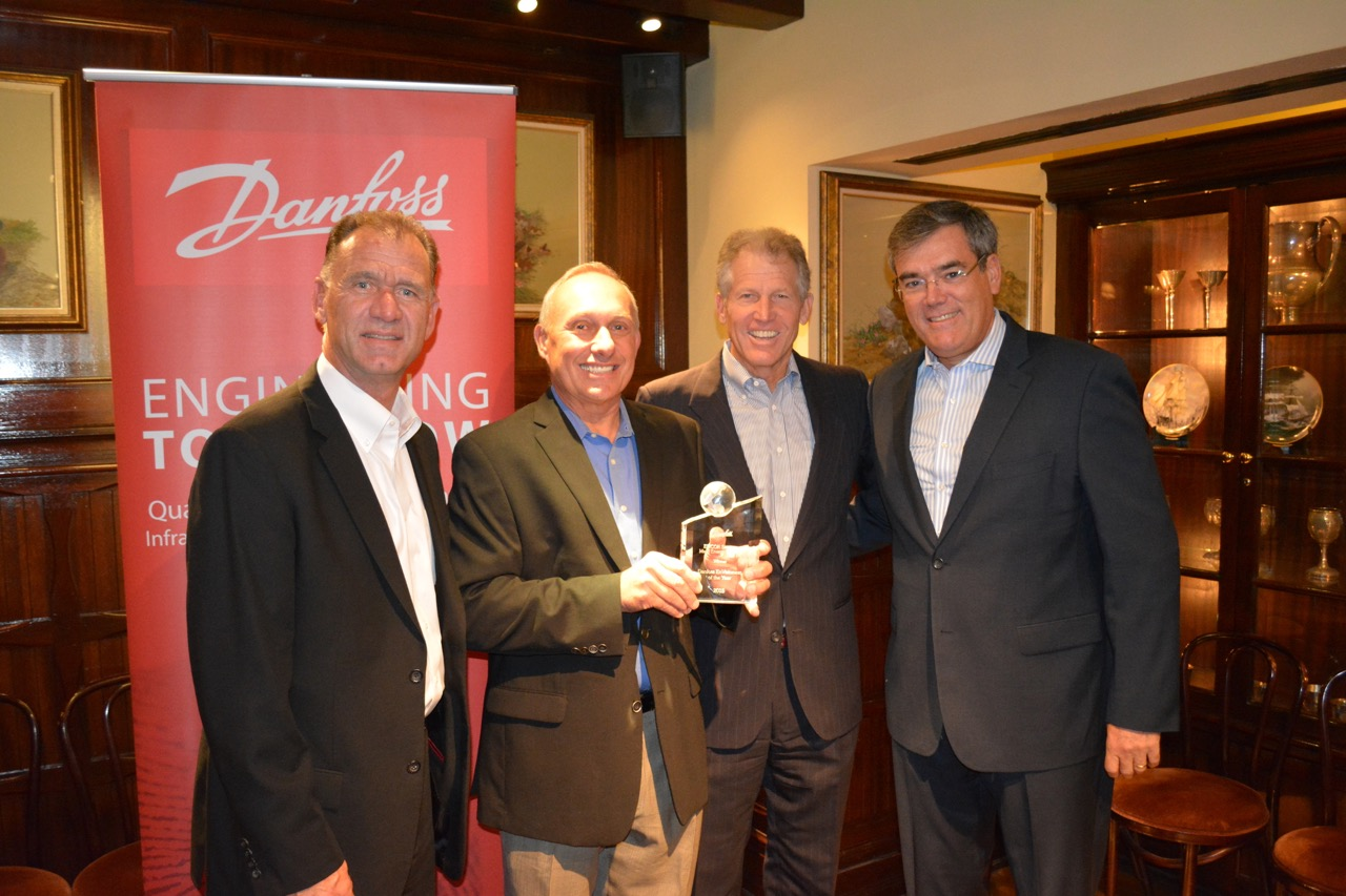 Danfoss presents the 2015 EnVisioneer of the Year award to EMCOR Services Mesa Energy Systems Pictured left to right John Galyen president Danfoss North America Charles Fletcher executive vice president EMCOR Services Mesa Energy Systems Robert Lake president and CEO EMCOR Services Mesa Energy Systems and Ricardo Schneider president Danfoss Turbocor Compressors