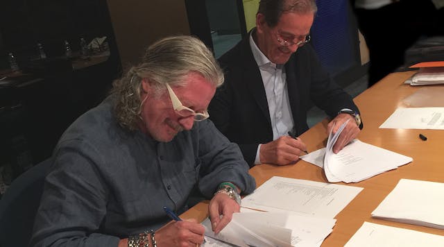 Taco&apos;s John Hazen White, Jr. and Elio Marioni of Askoll sign sale documents in Dueville, Italy.