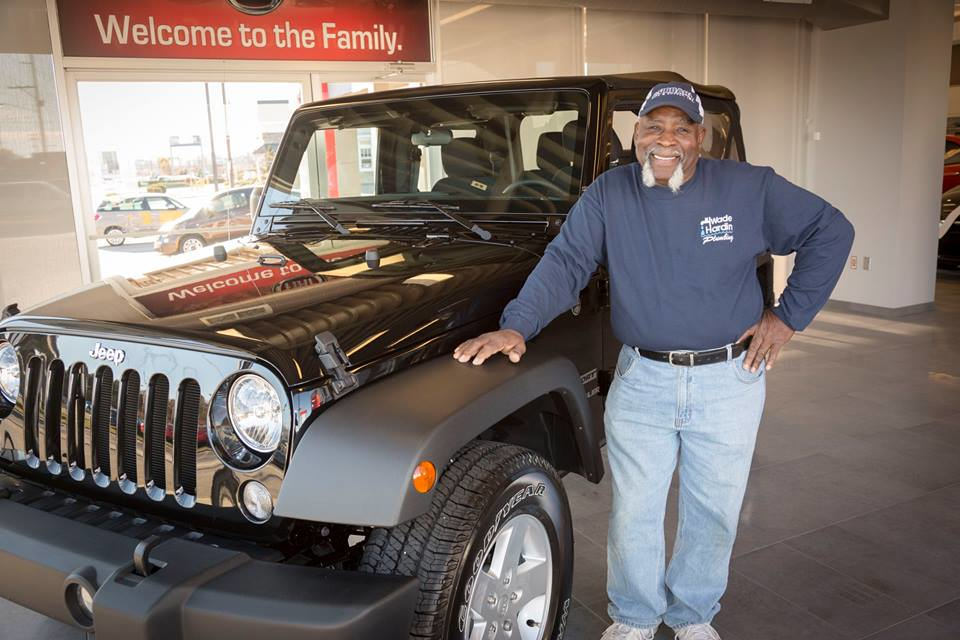 James Blue senior service technician with Wade Hardin Plumbing poses next to his new Jeep Wrangler