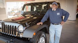 James Blue, senior service technician with Wade Hardin Plumbing poses next to his new Jeep Wrangler.
