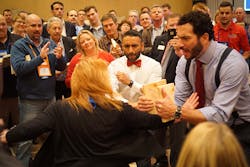Nexstar member Tammy Ferris breaking through a board held by Keith Mercurio while Nexstar Training Manager Julian Scadden and the crowd cheer her on Nexstar member Tammy Ferris breaking through a board held by Keith Mercurio while Nexstar Training Manager Julian Scadden and the crowd cheer her on