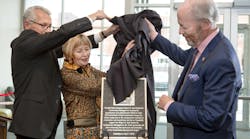 Terry King (left), Ball State&apos;s acting president, assists Diane and Robert G. Hunt with the unveiling of a plaque recognizing the couple&apos;s support of the university and its construction management program.