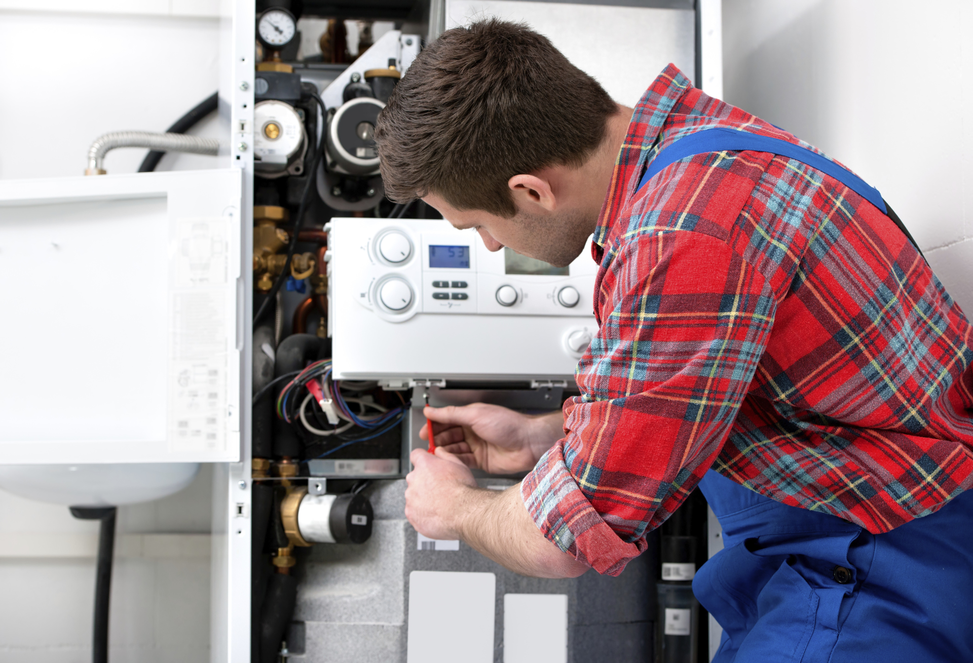 A technician servicing a boiler