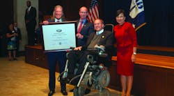 John Hazen White, Jr., Chairman and CEO of Taco Comfort Solutions holds the U.S. Department of Commerce &ldquo;E&rdquo; Award at Monday&rsquo;s ceremony in Washington, D.C. With him are Wil VandeWiel, Taco COO, RI Congressman James Langevin and Penny Pritzker, U.S. Secretary of Commerce.