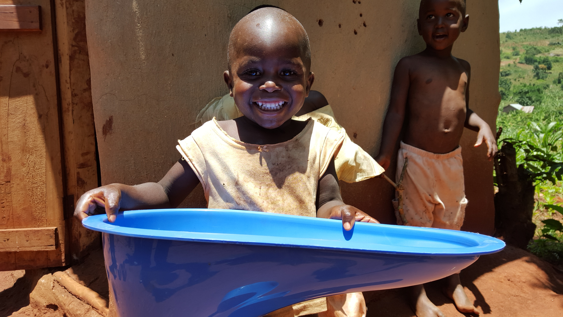 A young boy holds up one of the SaTo toilets