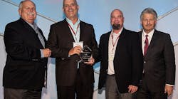 David Weekley (left) and Bill Justus (right), vice president of Supply Chain Services at David Weekley Homes, present the Partners of Choice Award to Carl Hines, national builder sales manager, and Tom Stewart, regional sales director, at Uponor.