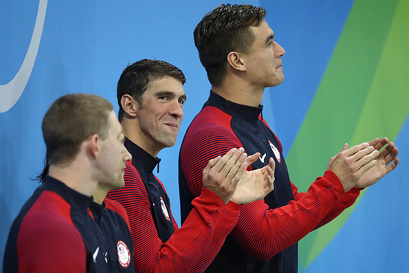 Gold medalist Michael Phelps of the United States celebrates on the podium during the medal ceremony for the Men39s 4 x 100m Medley Relay Final on Day 8 of the Rio 2016 Olympic Games at the Olympic Aquatics Stadium on August 13 2016 in Rio de Janeiro Brazil Image Al Bello Staff Getty Images Sports