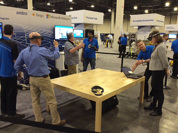 Attendees at the Trimble Dimensions conference in Las Vegas test drive the Microsoft HoloLens augmented reality headset loaded with building data from Trimble SketchUp and transmitted to the headset via Trimble Connect