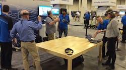 Attendees at the Trimble Dimensions conference in Las Vegas test drive the Microsoft HoloLens augmented reality headset loaded with building data from Trimble SketchUp and transmitted to the headset via Trimble Connect.