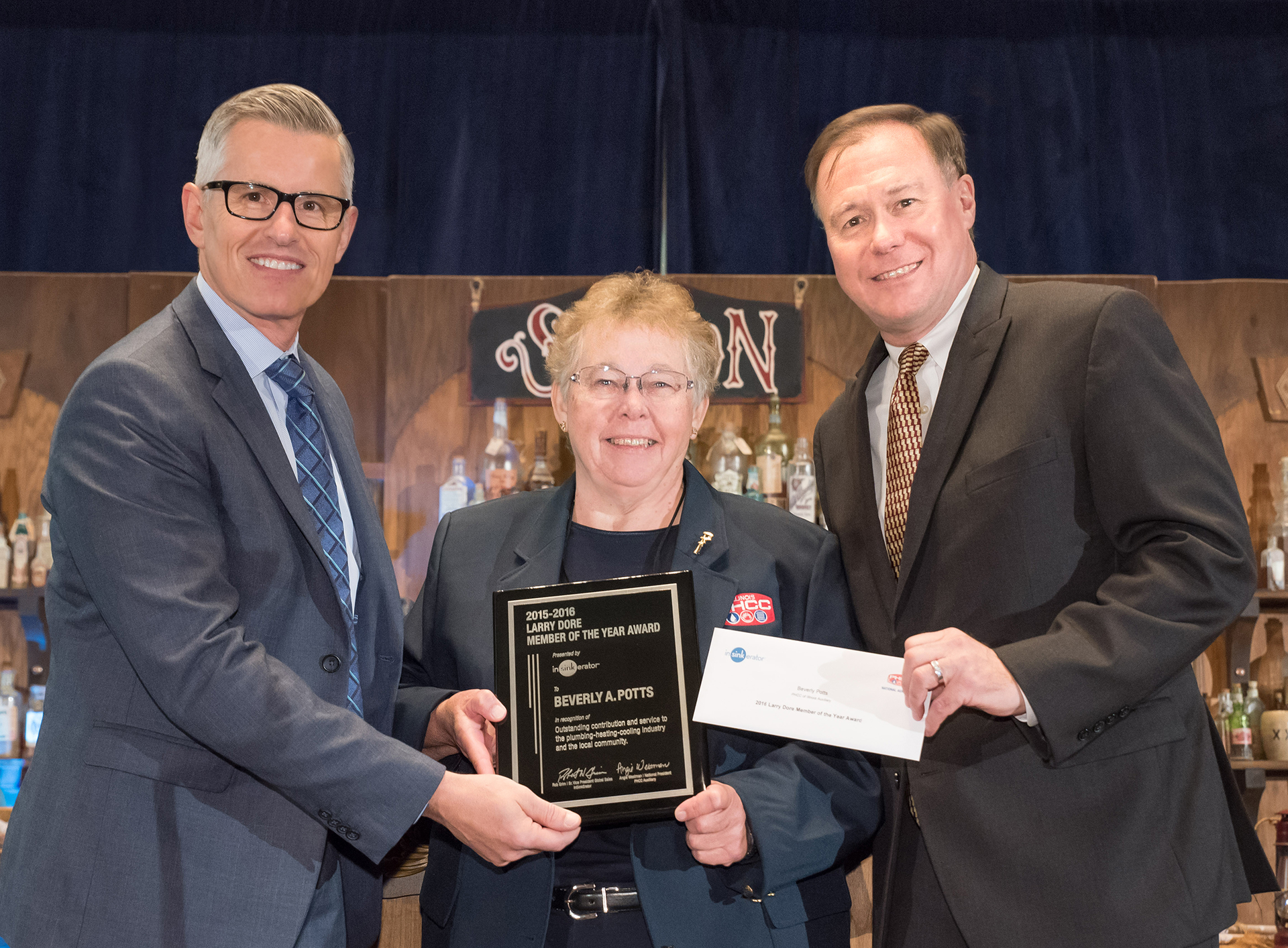 InSinkEratorreg presented Beverly Potts the PHCC Auxiliaryrsquos Member of the Year award in October at the PHCC national convention in San Antonio Pictured are lr Chad Severson InSinkErator President Beverly Potts PHCC Auxiliaryrsquos Member of the Year and Rob Grim InSinkErator Senior Vice President Global Sales