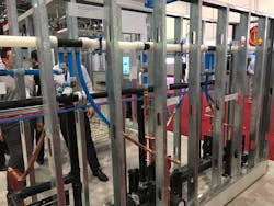 Uponorrsquos booth included a sample of a wall of backtoback fixture carriers with large diameter PEX and copper stubouts Uponorrsquos booth included a sample of a wall of backtoback fixture carriers with large diameter PEX and copper stubouts