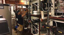 A Nelson Mechanical tech begins disassembling the failed heat pump. The project was complicated by difficult access to the mechanical room – through a finished hallway and set of stairs. Extra care had to be taken with demolition and with the transport of the new heat pumps through the finished spaces. A Nelson Mechanical tech begins disassembling the failed heat pump. The project was complicated by difficult access to the mechanical room – through a finished hallway and set of stairs. Extra care had to be taken with demolition and with the transport of the new heat pumps through the finished spaces.