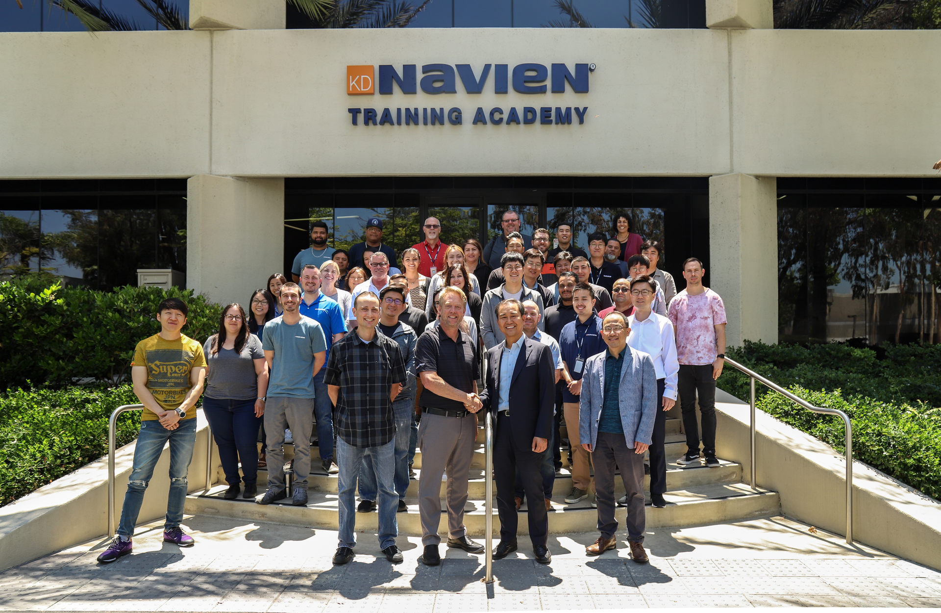 CEO, Scott Lee, congratulates VP, Eric Moffroid, on behalf of the whole company sales excellence.jpg