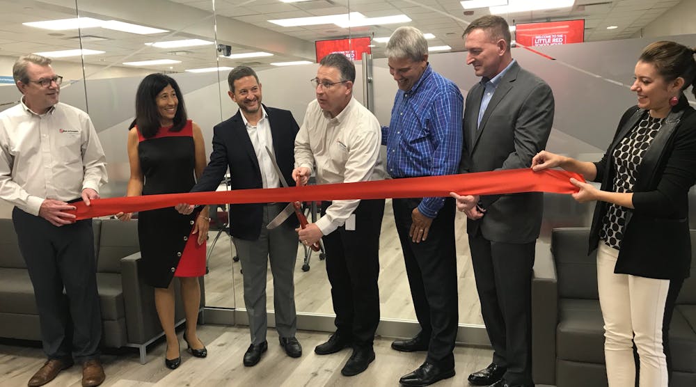 Mike Licastro, Training &amp; Education Manager, Commercial Building Services &amp; HVAC, Xylem Inc., cuts the ribbon for the grand re-opening of the Little Red Schoolhouse.