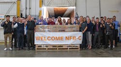 A group of Navien workers pose with the first shipment.