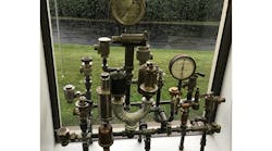 A display of traps, vents, and valves that have been graciously gifted the author over the years, currently on display in his office.