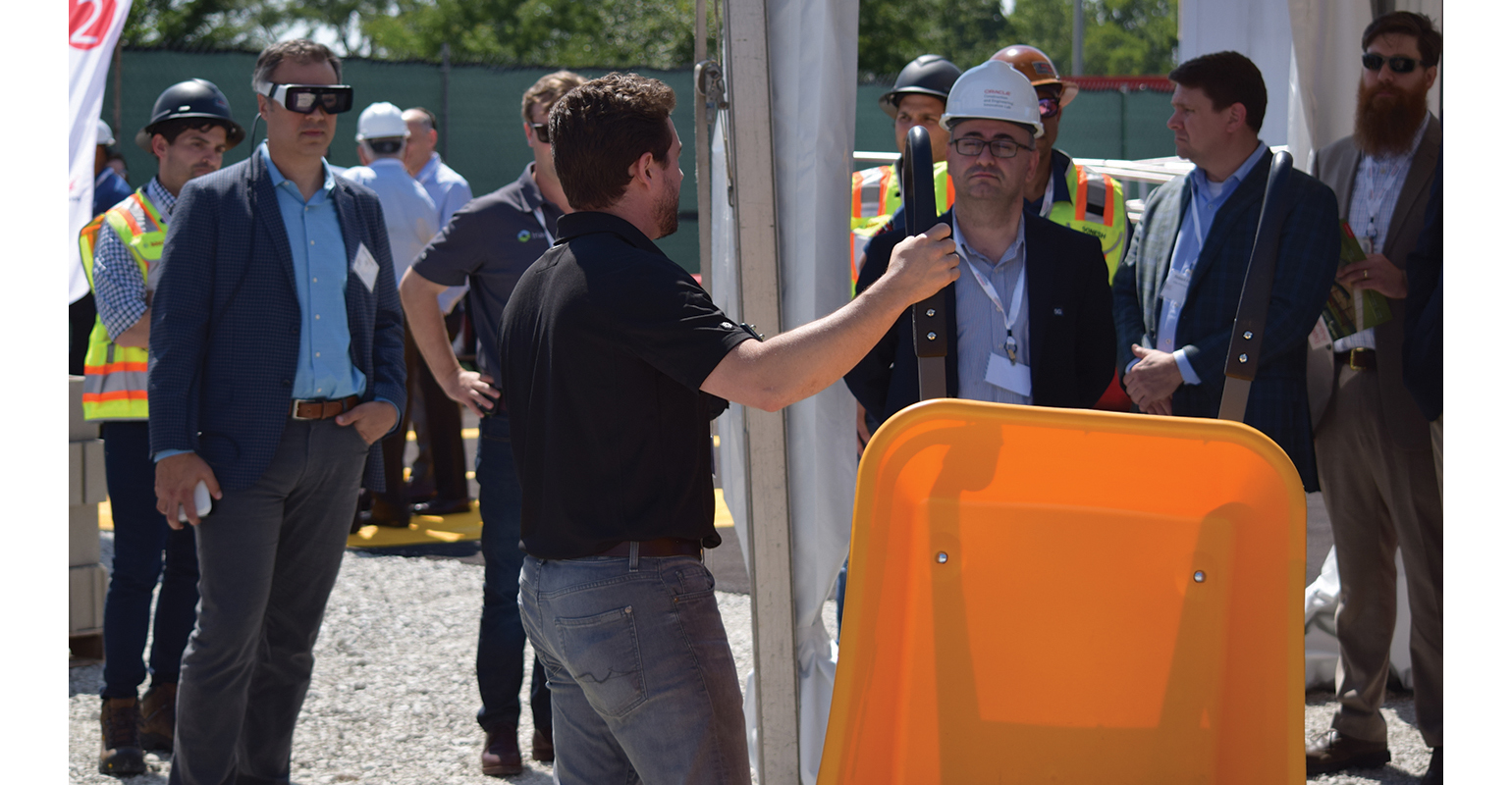 Visitors to the Oracle Construction and Engineering Innovation Lab take part in an experience focusing on worksite tracking solutions from Triax.