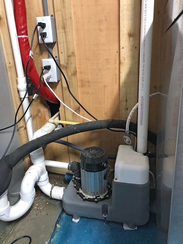 The Sanicom 1 unit installed to discharge the gray water from three hand-sinks and three tub-dishwashing sinks in the bar area. The unit&rsquo;s 1-inch discharge pipe (top left) runs eight feet vertically and connects to an existing wastewater line.