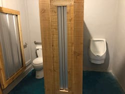 A urinal and toilet are connected to a Sanibest Pro in the men’s restroom. A urinal and toilet are connected to a Sanibest Pro in the men’s restroom.