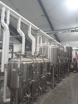 Stainless steel fermentation tanks. Stainless steel fermentation tanks.