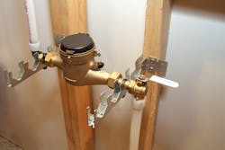 A water meter held on brackets.