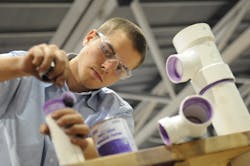 A plumbing trainee joins PVC pipe at a skilled trades competition. This year was the first time the contests were held virtually. A plumbing trainee joins PVC pipe at a skilled trades competition. This year was the first time the contests were held virtually.