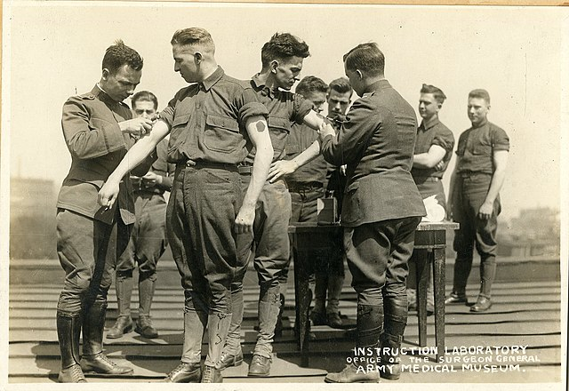 Soldiers being vaccinated at Army Medical School, circa WWI.