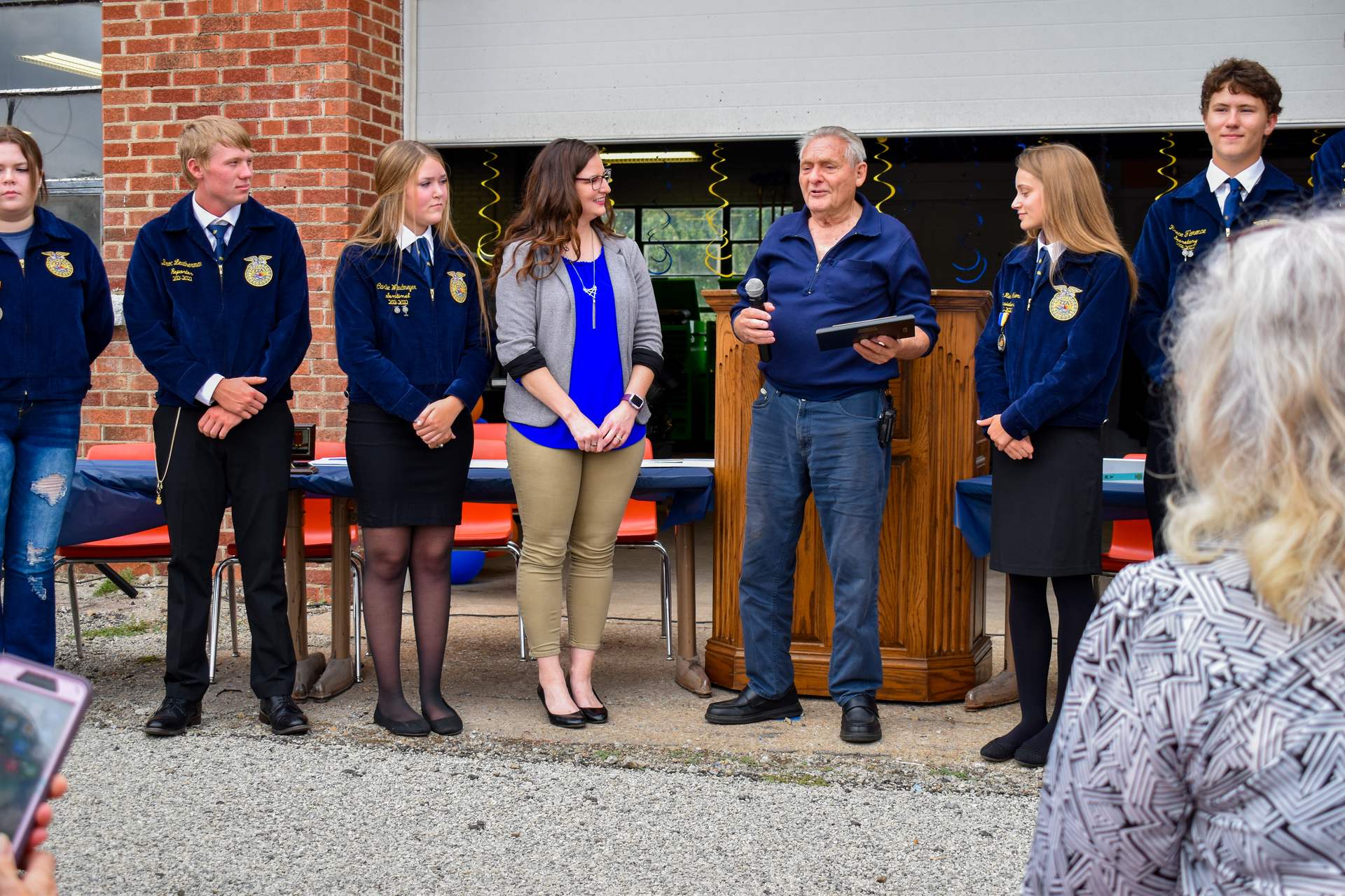Vern Lewis accepts a plaque from students and staff at Doniphan High School, his alma mater.