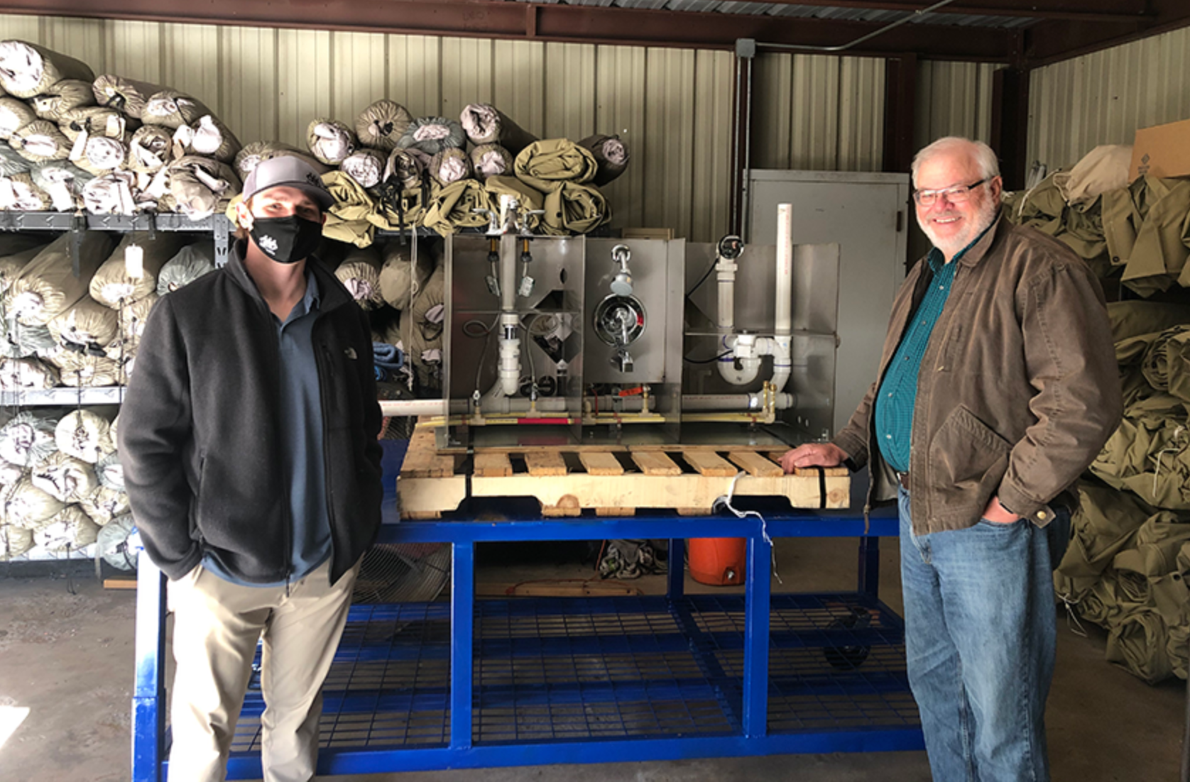 A TD technician and the camp chairman by the new interactive trainer.