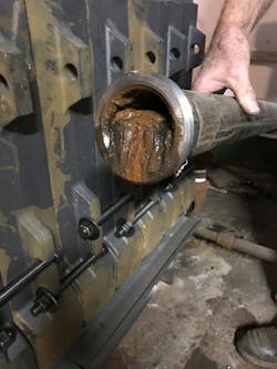 Photo 1-- the sludge has accumulated at the return connection to the boiler. Photo 1-- the sludge has accumulated at the return connection to the boiler.