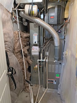 The Johnson Residence mechanical room with the old furnace and humidifier before the installation of the new combi boiler and air handler. The Johnson Residence mechanical room with the old furnace and humidifier before the installation of the new combi boiler and air handler.