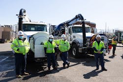 Cleaning crews in front of vacuum trucks. Cleaning crews in front of vacuum trucks.