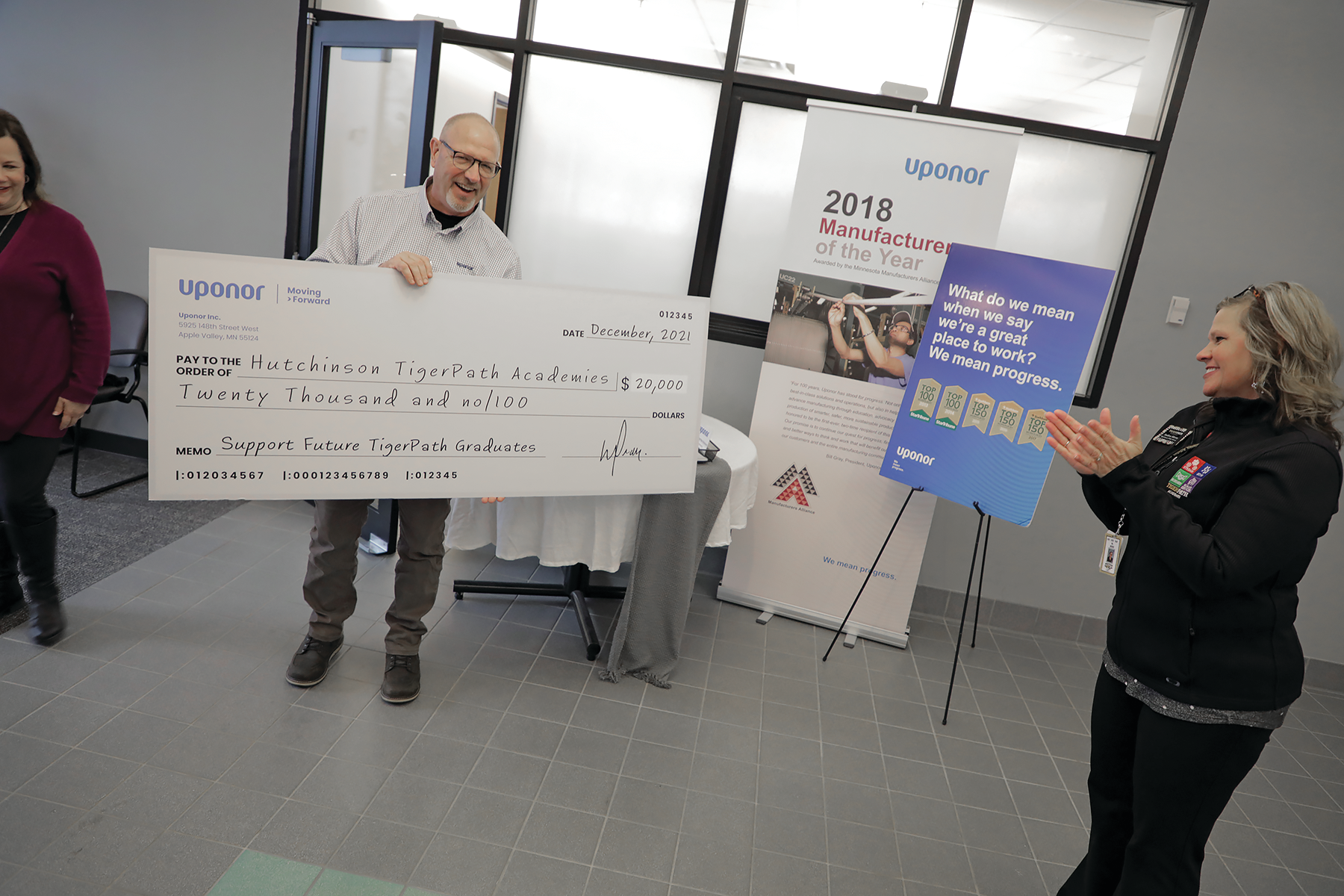 John Sommers, site manager, Uponor, presented a giant check for $20,000 to Andrea Moore, coordinator of Hutchinson TigerPath Academies. The donation will go towards funding educational initiatives for students at Hutchinson High School.