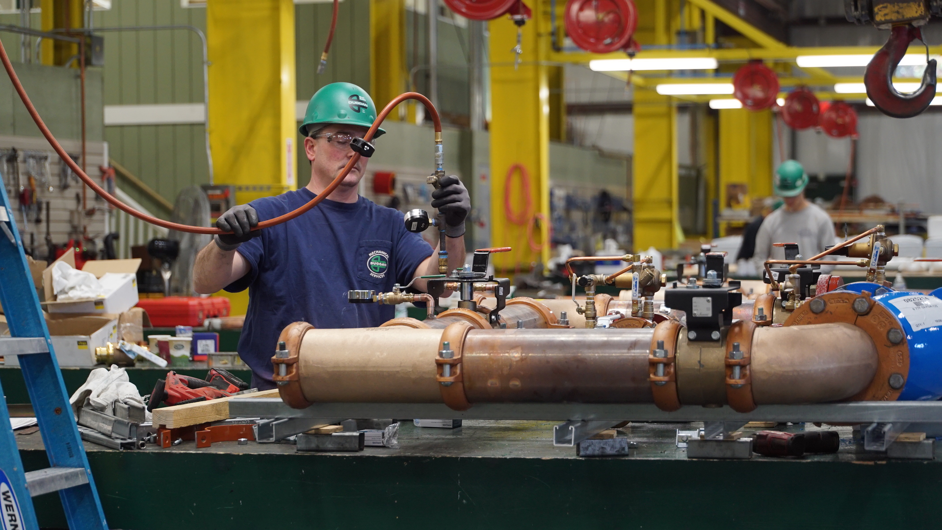 An E. M. Duggan technician working in the company plumbing prefab shop.