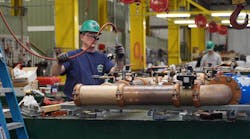 An E. M. Duggan technician working in the company plumbing prefab shop. An E. M. Duggan technician working in the company plumbing prefab shop.